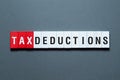 Tax deductions - word concept on building blocks, text