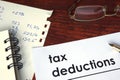 Tax deductions written on a paper. Royalty Free Stock Photo
