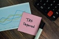 Tax Deferred write on sticky notes isolated on Wooden Table