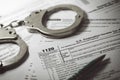 Tax evasion concept - tax form 1120 and handcuffs Royalty Free Stock Photo