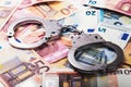 Tax evasion, corruption concept - handcuffs on euro money bills