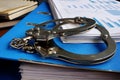 Tax evasion. Handcuffs and pile of financial papers