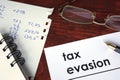 Tax evasion written on a paper. Royalty Free Stock Photo
