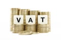 VAT (Value Added Tax) on gold coins on white backg Royalty Free Stock Photo