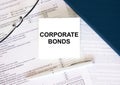 Tax form with business card with text Corporate Bonds. Notepad, eyeglasses and white pen Royalty Free Stock Photo