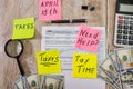 Tax form 1040 with a calculator, dollars and pen on a wooden table. View from above. Tax concept. Tax time. Royalty Free Stock Photo