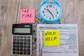 Tax form 1040, dollars, calculator and blue alarm clock on a wooden table.View from above Royalty Free Stock Photo