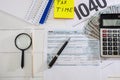 Tax form 1040, dollars, pen and calculator on the table. Business concept. View from above. Royalty Free Stock Photo