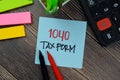 1040 Tax Form write on sticky notes isolated on Wooden Table Royalty Free Stock Photo