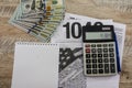 Tax forms 1040, calculator, dollars, notepad and pen on a wooden background Royalty Free Stock Photo