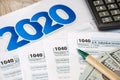 Tax forms 1040, calculator, dollars and pen on the table Royalty Free Stock Photo