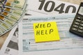 Tax forms 1040, calculator and dollars on a wooden background, close-up