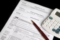 Tax forms with calculator and pen