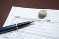 Tax forms, coins and pen Royalty Free Stock Photo