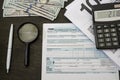 Tax forms 1040, dollars, notepad, calculator and pen. Financial document. Tax concept. Royalty Free Stock Photo