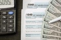 Tax forms 1040, dollars, notepad, calculator and pen. Financial document. Tax concept. Royalty Free Stock Photo