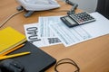 Tax forms 1040, laptop, office phone on the table