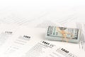 Tax forms lies near roll of hundred dollar bills. Income tax return Royalty Free Stock Photo