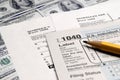 Tax Forms on top of Money Royalty Free Stock Photo