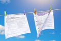 Tax forms were washed and dried in the open air. Papers are dried on a clothesline in sunny summer weather Royalty Free Stock Photo