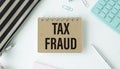 Tax Fraud text on notepad on write office Royalty Free Stock Photo