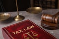 Tax law book and gavel on grey marble table Royalty Free Stock Photo