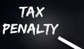 TAX PENALTY Text on Black Chalkboard with a piece of chalk Royalty Free Stock Photo