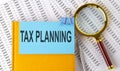 TAX PLANNING text on sticker on notebook with magnifier and chart. Business concept Royalty Free Stock Photo