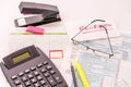 Tax preparation supplies, reading glasses and tax forms Royalty Free Stock Photo