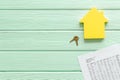 Tax for property accounting with house figure, keys and table on mint green wooden background top view copyspace