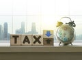 Tax reduction business and financial concept. Wooden blocks with the word TAX and a blue upside down arrow Royalty Free Stock Photo