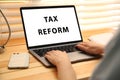 Tax reform concept. Woman working with modern laptop at wooden table, closeup Royalty Free Stock Photo
