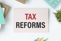 Tax Reform text on paper on the desk. Business concept for Government Change in Taxes written on sticky Royalty Free Stock Photo