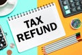 TAX REFUND with the office tools on yellow blue background . Concept TAX REFUND Royalty Free Stock Photo