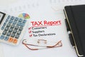 Tax report on a desk with tick against customers, suppliers and tax declarations