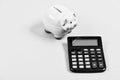 Tax savings. Piggy bank money savings. Investing gain profit. Pay taxes. Calculate taxes. Piggy bank pig and calculator Royalty Free Stock Photo