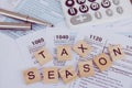 Tax season with wooden alphabet blocks, calculator, pen on 1040 tax form background Royalty Free Stock Photo