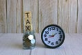 Tax text on wooden block cube on top of glass jar with multicurrency coins