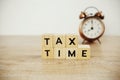 Tax Time and alarm clock with space copy on wooden background Royalty Free Stock Photo