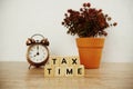 Tax Time and alarm clock with space copy on wooden background Royalty Free Stock Photo