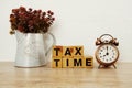 Tax Time with alarm clock with space copy on wooden background Royalty Free Stock Photo