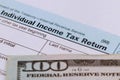 Tax time Closeup of U.S. 1040 tax return with 100 bills Royalty Free Stock Photo