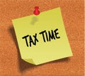 TAX TIME handwritten on yellow sticky paper note over cork noticeboard background. Royalty Free Stock Photo