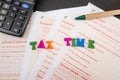 `tax time` laid out from the letters on the background of the Australian tax forms / calculator and pen. View from above. Tax conc Royalty Free Stock Photo