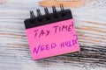 Tax time message on a paper of mini notepad. Royalty Free Stock Photo