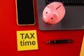 Tax time - notification of the need to file tax returns, tax form at accauntant workplace. Piggy bank in pink color with