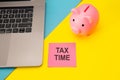 Tax time - notification of the need to file tax returns, tax form at accauntant workplace. Piggy bank in pink color with