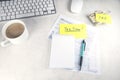 Tax time - Notification of need to file tax returns, tax form at accountant`s workplace. Top view of notepad, stickers, cup of