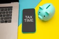 Tax time - notification of the need to file tax returns, tax form at accauntant workplace. Piggy bank in blue color with