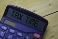 Tax time write on the calculator with wooden table background